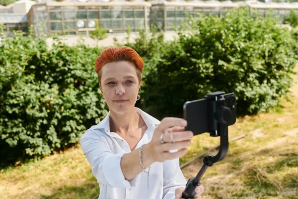 A young teacher with red hair takes a selfie on a sunny day. — Stock Photo