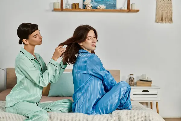 A young lesbian couple relaxes in pajamas, enjoying a quiet morning together. — Stock Photo
