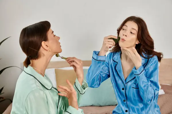 A lesbian couple relaxes in pajamas, enjoying a quiet morning routine together. — Stock Photo