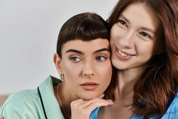 Two women in pajamas share a tender moment, their faces close together, radiating love and contentment. — Stock Photo