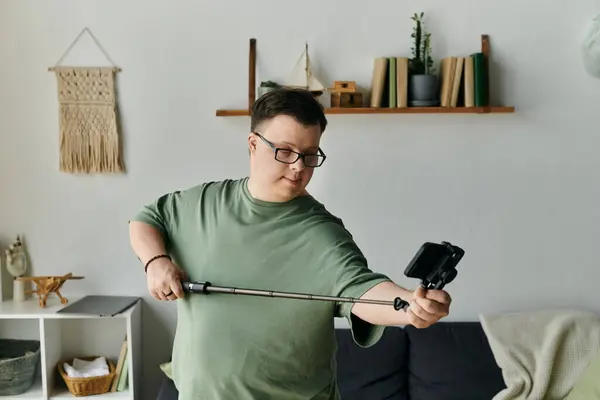 A young man with Down syndrome joyfully captures a selfie in his cozy living room. — Stock Photo