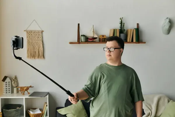 A young man with Down syndrome engages in a joyful self portrait session indoors. — Stock Photo