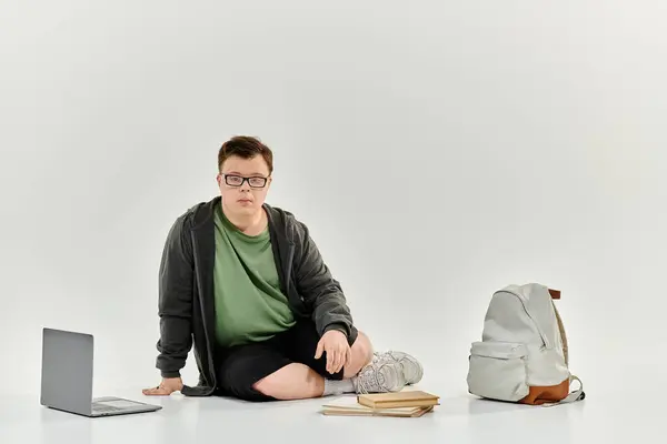 A young man with Down syndrome engages with his homework in a cozy home setting. — Stock Photo