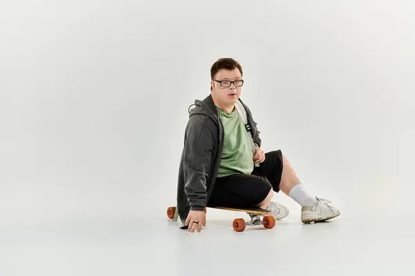 A young man with Down syndrome skates at home, showcasing his joy and confidence. — Stock Photo