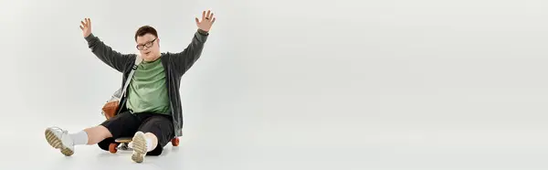 A man with Down syndrome expresses happiness while sitting with open arms. — Stock Photo