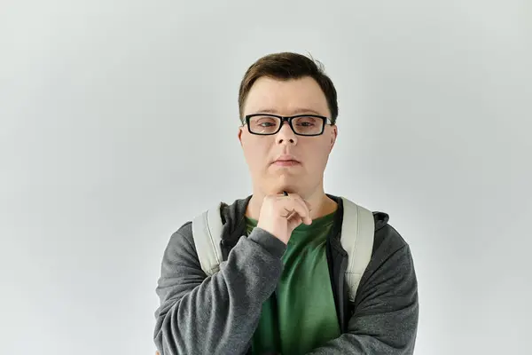 A man with Down syndrome contemplates in a serene indoor environment. — Stock Photo