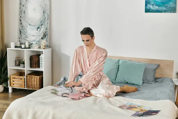 A stylish drag queen relaxes while browsing fashion magazines at home. — Stock Photo