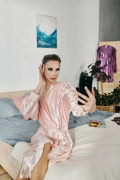 A young drag queen poses elegantly while taking a selfie. — Stock Photo