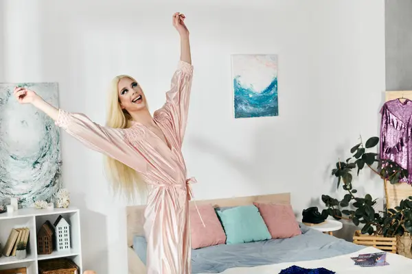 An attractive young drag queen expresses joy in a stylish bedroom setting. — Stock Photo