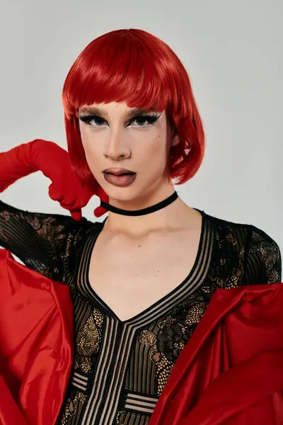 An attractive young drag queen poses with flair, showcasing bold makeup and vivid attire. — Stock Photo