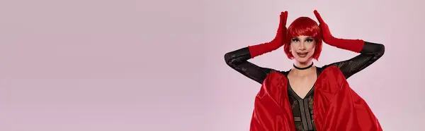 An attractive drag queen showcases a stunning red outfit and playful pose. — Stock Photo