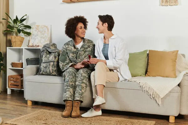 Un adiós amoroso se desarrolla como un soldado en camuflaje consuela a su pareja en casa, haciendo propuesta de matrimonio — Stock Photo