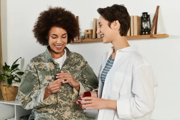 Happy african american female soldier wearing engagement ring, marriage proposal — Stock Photo