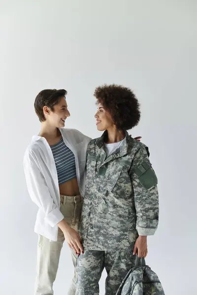A young couple shares a heartfelt moment as one prepares for military service, showcasing love and support. — Stock Photo