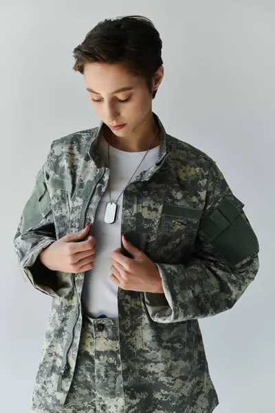 Female soldier prepares for military service in a studio setting. — Stock Photo