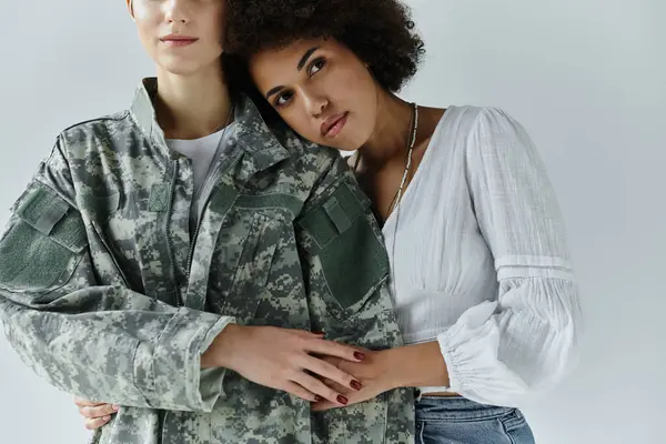 A soldier embraces her wife, showcasing love and support in a heartfelt farewell moment. — Stock Photo