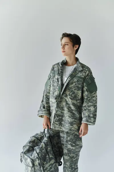 A young woman in military uniform standing before deployment. — Stock Photo