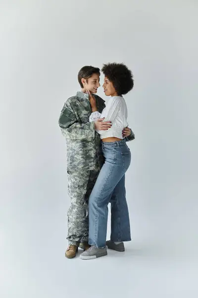 A young couple shares a tender moment as one prepares for military service. — Stock Photo