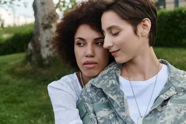 A joyful reunion as a soldier is warmly embraced by her loving wife on returning home. — Stock Photo