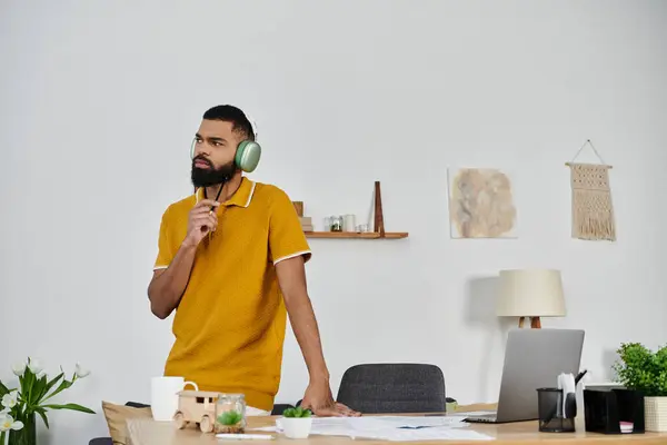 A thoughtful man listening to music, immersed in a creative moment at home. — Stock Photo