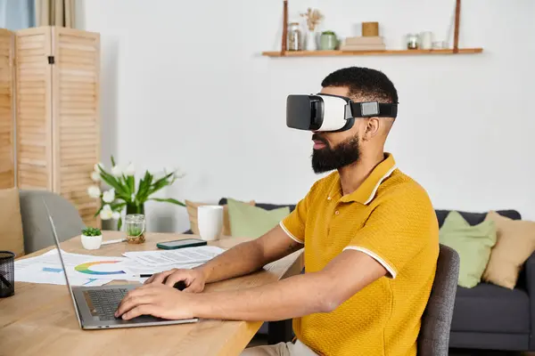 A man experiences virtual reality while seated at his workspace. — Stock Photo
