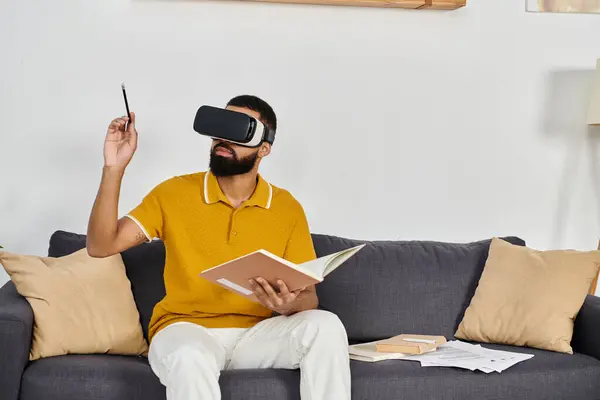 Man explores virtual worlds while relaxing on his sofa. — Stock Photo