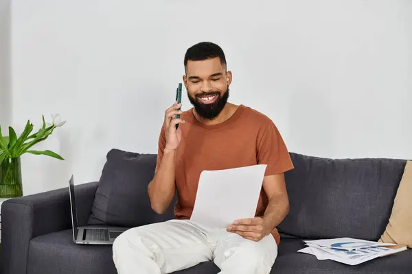 Happy man chatting on the phone while going through important documents. — Stock Photo