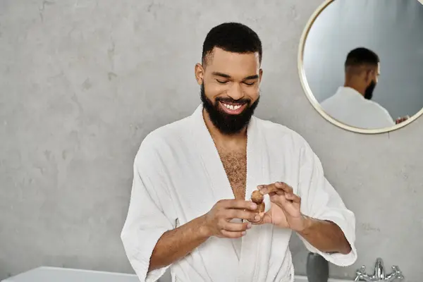 A man enjoys a moment of self care in a stylish bathroom. — Stock Photo