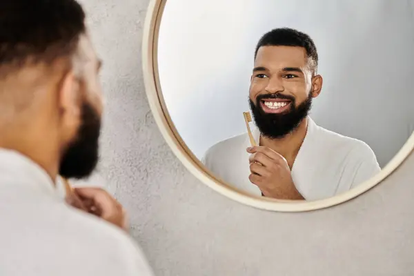 A cheerful man enjoying his morning brushing routine at home. — Stock Photo