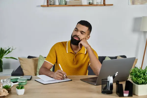 A man reflects while jotting ideas in his notebook during a quiet afternoon. — Stock Photo