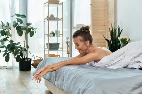 Young woman enjoys a tranquil moment in sensual lingerie amidst a stylish bedroom setting. — Stock Photo