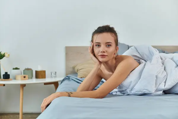 A young woman poses gracefully in lingerie, exuding confidence and serenity. — Stock Photo