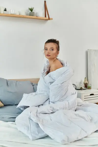 A young woman exudes confidence, wrapped in soft fabrics in a serene bedroom. — Stock Photo