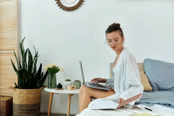 A young woman explores documents while seated in a stylish bedroom. — Stock Photo