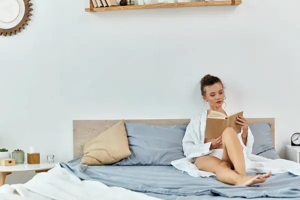 Captivating young woman exploring a novel while lounging in a beautiful bedroom. — Stock Photo
