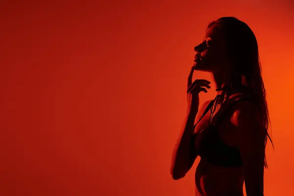 Une jeune femme gracieusement en lingerie séduisante, baignée de lumière chaude. — Photo de stock