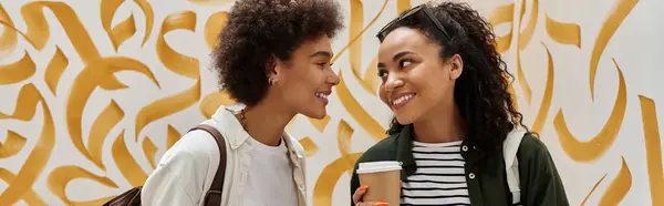 Two happy travelers enjoy each others company in a vibrant hostel — Stock Photo