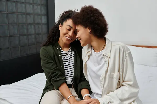 A happy couple shares laughter and warmth while relaxing in their hotel room. — Stock Photo