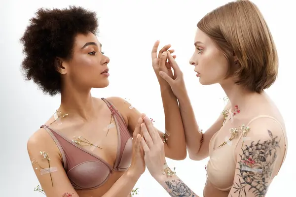 A loving moment shared as two women explore their bond creatively. — Stock Photo