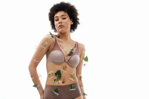 Pretty curly haired african american woman in pastel cozy underwear with flowers on body. — Stock Photo