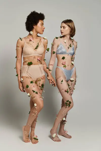 Two women stand close, connecting in a shared moment surrounded by flowers. — Stock Photo