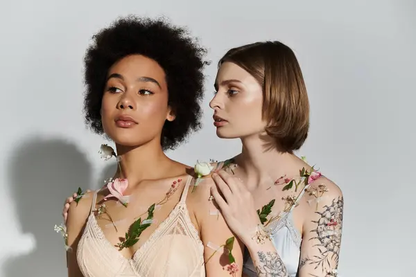 Two women adorned with flowers share a tender moment of connection and love. — Stock Photo