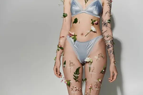 Young woman with plants on her body wearing underwear. — Stock Photo