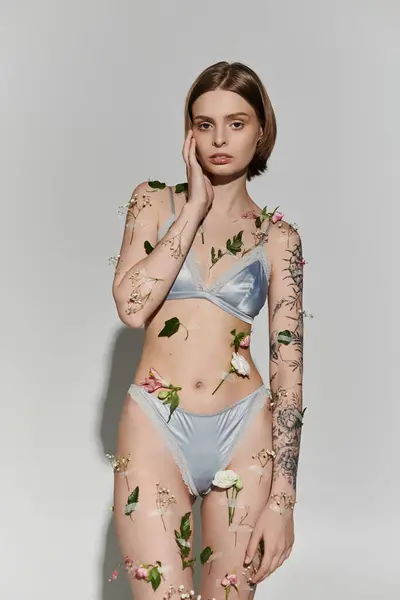 Good looking woman with plants on her body wearing underwear. — Stock Photo