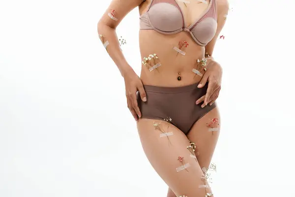African american woman posing with flowers on body and underwear. — Stock Photo