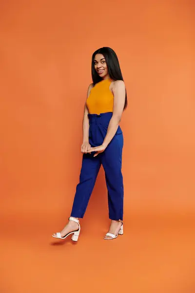 African american young woman showcases her outfit with confidence and grace. — Stock Photo