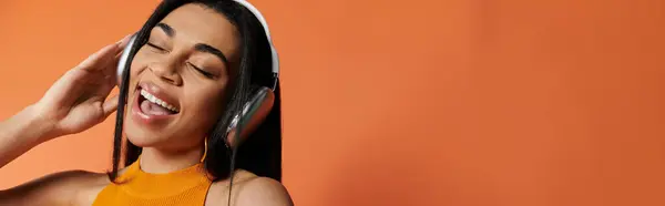Singing along while wearing headphones, exuding happiness and passion for music. — Stock Photo