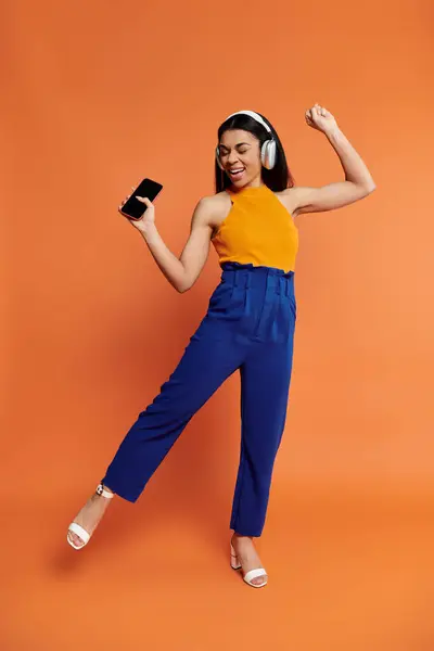 A joyful woman dances with headphones, embracing the rhythm of the moment. — Stock Photo