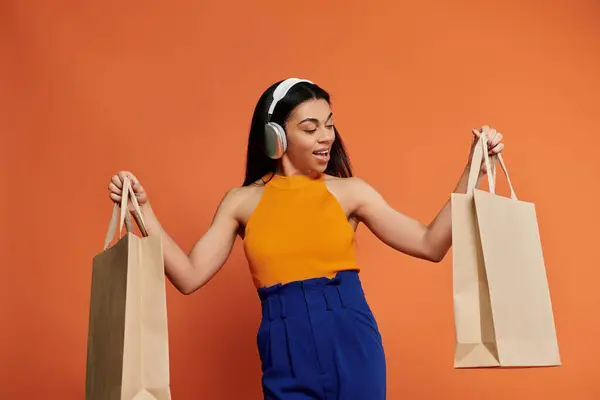 A joyful woman experiences the thrill of shopping with bags in hand. — Stock Photo