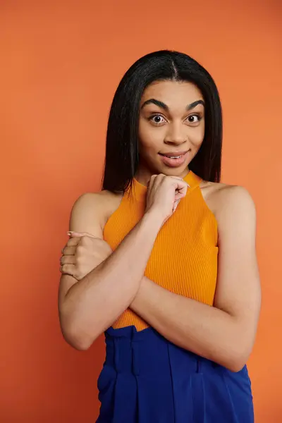 A confident woman poses playfully, showcasing her unique style and vibrant energy. — Stock Photo